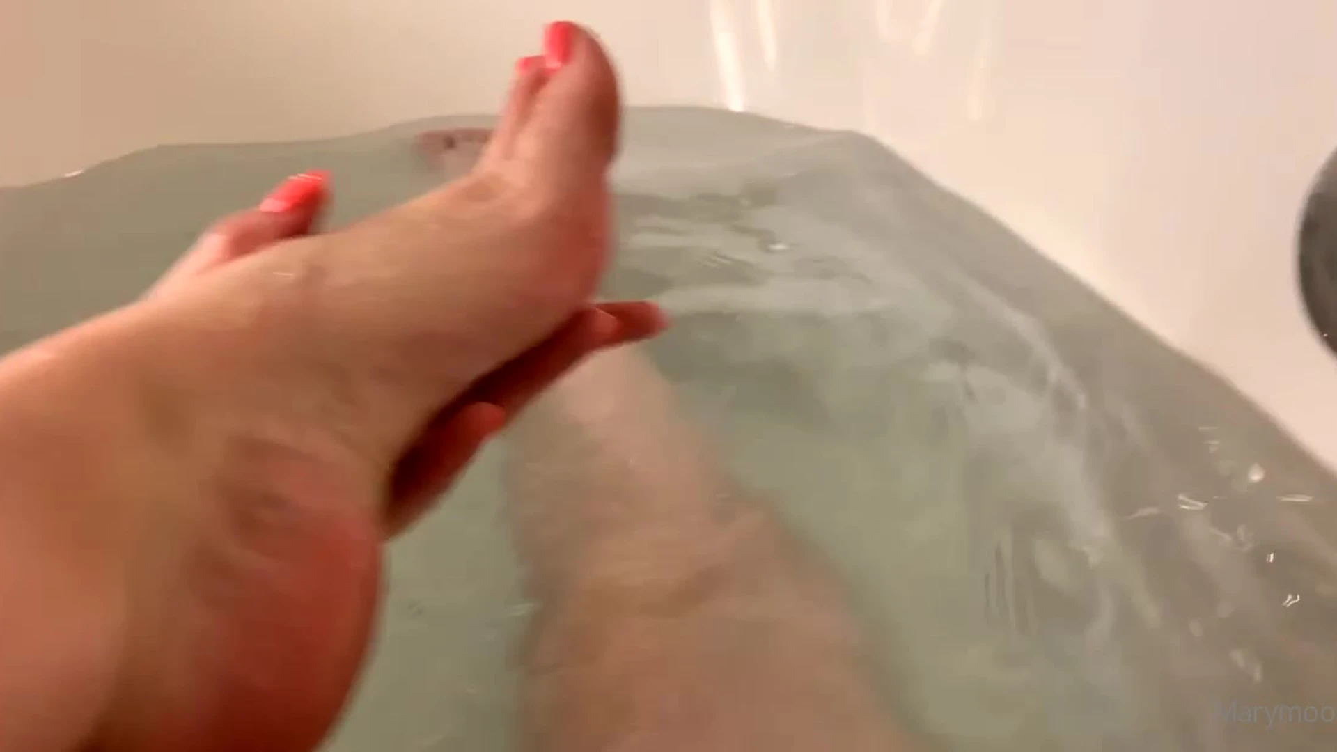 Mary Moody shows off her feet while taking a bath in the tub